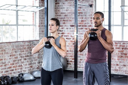 simsearch:689-03131217,k - Fit couple lifting kettle bells Stock Photo - Premium Royalty-Free, Code: 6109-08396990