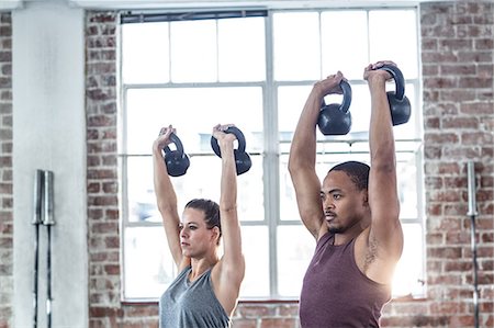 simsearch:689-03131217,k - Fit couple lifting kettle bells Stock Photo - Premium Royalty-Free, Code: 6109-08396992