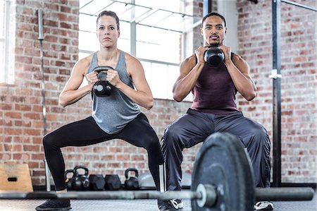 simsearch:689-03131217,k - Fit couple lifting kettle bells Stock Photo - Premium Royalty-Free, Code: 6109-08396995