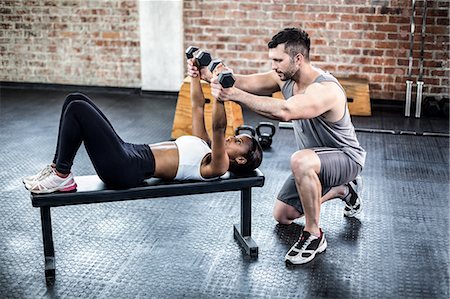 simsearch:6109-07497839,k - Personal trainer working with client holding dumbbell Stock Photo - Premium Royalty-Free, Code: 6109-08396912