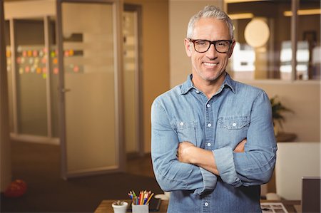 Portrait of creative businessman with arms crossed Stock Photo - Premium Royalty-Free, Code: 6109-08397633