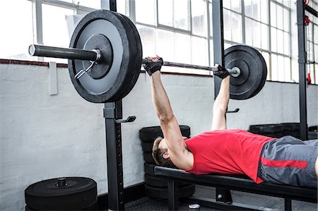 simsearch:6109-08397867,k - Fit man lifting heavy barbell Stock Photo - Premium Royalty-Free, Code: 6109-08397842