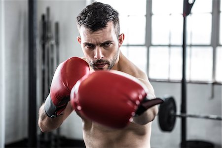 simsearch:6109-08397867,k - Fit man boxing with gloves Stock Photo - Premium Royalty-Free, Code: 6109-08397814