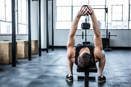 Fit man lifting heavy black dumbbell Stock Photo - Premium Royalty-Free, Code: 6109-08397998