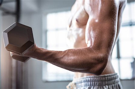 Fit shirtless man lifting dumbbells Stock Photo - Premium Royalty-Free, Code: 6109-08398063