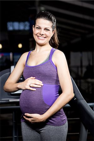 simsearch:6109-08398593,k - Pregnant woman touching belly Stock Photo - Premium Royalty-Free, Code: 6109-08398597
