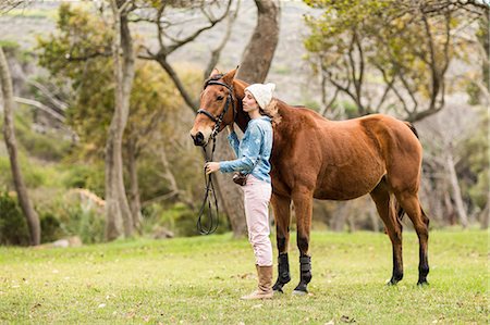 saddle - Young woman hugging her horse Stock Photo - Premium Royalty-Free, Code: 6109-08398513