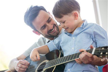 Father teaching son to play guitar Foto de stock - Sin royalties Premium, Código: 6109-08398851