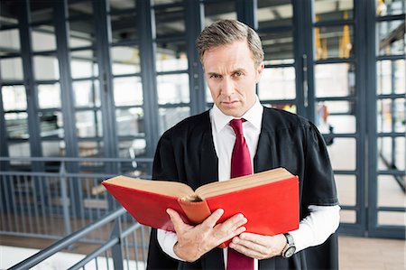 Lawyer reading a book attentively Stock Photo - Premium Royalty-Free, Code: 6109-08399258