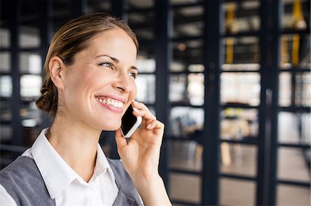 simsearch:6109-06685044,k - Portrait of a smiling businesswoman having a phone call Stock Photo - Premium Royalty-Free, Code: 6109-08399224