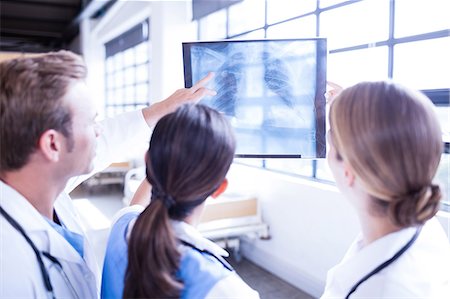 doctor intern male white - Medical team looking at x-ray together Stock Photo - Premium Royalty-Free, Code: 6109-08399355