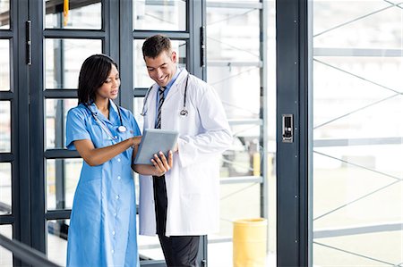 doctor intern male white - Nurse and doctor looking at a tablet Stock Photo - Premium Royalty-Free, Code: 6109-08399324