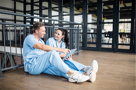 simsearch:6109-06005907,k - Smiling medical team working on floor Stock Photo - Premium Royalty-Free, Code: 6109-08399329