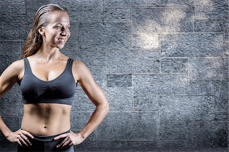 Composite image of cheerful athlete with hands on hip Stock Photo - Premium Royalty-Free, Code: 6109-08399426