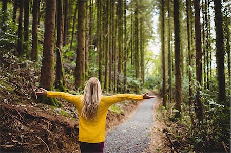 simsearch:6109-08481684,k - Beautiful blonde woman with arms outstretched in the woods Foto de stock - Sin royalties Premium, Código: 6109-08481690