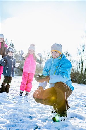 Family holding snowballs on a beautiful snowy day Stock Photo - Premium Royalty-Free, Code: 6109-08481773