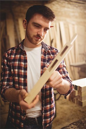 simsearch:6102-07158067,k - Carpenter working on his craft in a dusty workshop Stock Photo - Premium Royalty-Free, Code: 6109-08481886