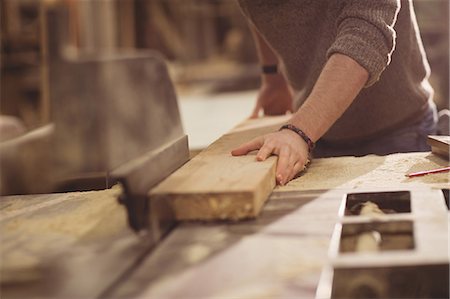 simsearch:6102-07158067,k - Carpenter working on his craft in a dusty workshop Stock Photo - Premium Royalty-Free, Code: 6109-08481913