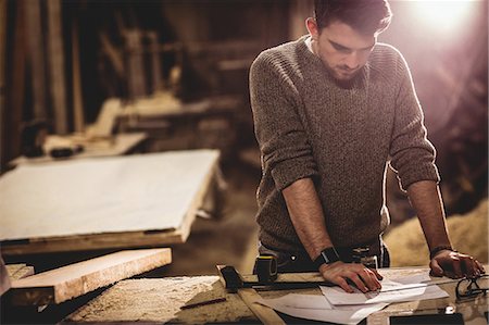 simsearch:6102-07158067,k - Carpenter working on his craft in a dusty workshop Stock Photo - Premium Royalty-Free, Code: 6109-08481915