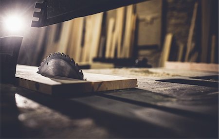 sawing - Saw sawing plank of wood in a dusty workshop Stock Photo - Premium Royalty-Free, Code: 6109-08481925