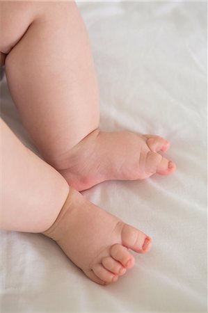simsearch:6109-07497438,k - Beautiful cute feet of baby at home in bedroom Stock Photo - Premium Royalty-Free, Code: 6109-08488602