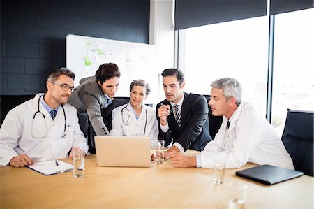 simsearch:6109-08804356,k - Medical team having a meeting at the office Stock Photo - Premium Royalty-Free, Code: 6109-08488866