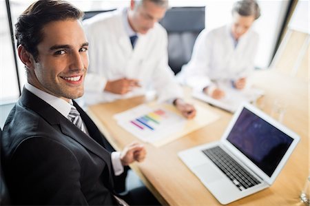 simsearch:6109-08804356,k - Medical team having a meeting at the office Stock Photo - Premium Royalty-Free, Code: 6109-08488873