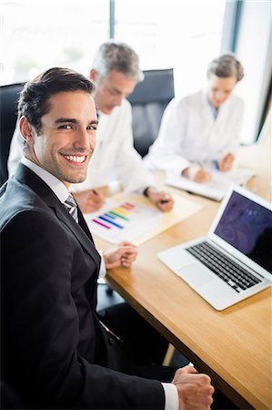 simsearch:6109-08804356,k - Medical team having a meeting at the office Stock Photo - Premium Royalty-Free, Code: 6109-08488874