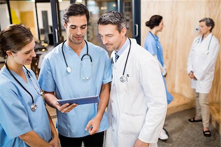 simsearch:6109-06005907,k - Medical team standing and talking at the hospital Stock Photo - Premium Royalty-Free, Code: 6109-08488894