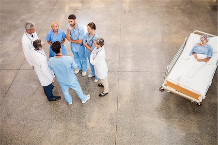 doctor adult patient conversation - Medical team with patient on trolley at the hospital Stock Photo - Premium Royalty-Free, Code: 6109-08488945