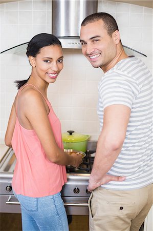 simsearch:6109-08390293,k - Smiling couple preparing vegetables in the kitchen at home Stock Photo - Premium Royalty-Free, Code: 6109-08489059