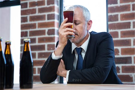 simsearch:6109-06684997,k - Tired businessman holding a beer in a pub Stock Photo - Premium Royalty-Free, Code: 6109-08489684