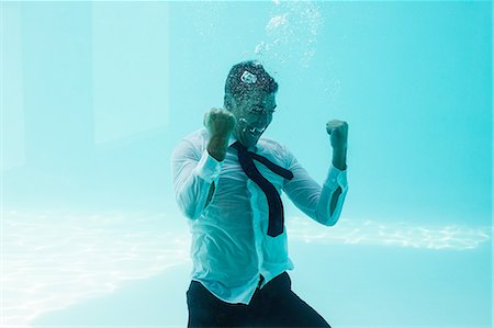 swimming class - Businessman cheering underwater in swimming pool Stock Photo - Premium Royalty-Free, Code: 6109-08489754