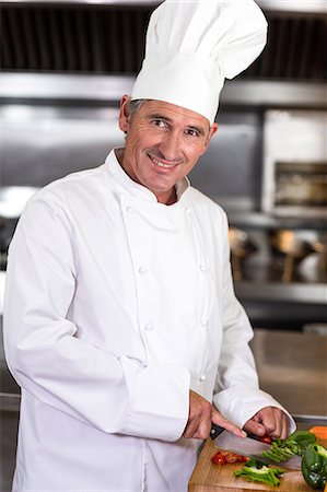 simsearch:6109-07601099,k - Chef preparing vegetables at counter in a commercial kitchen Stock Photo - Premium Royalty-Free, Code: 6109-08489842