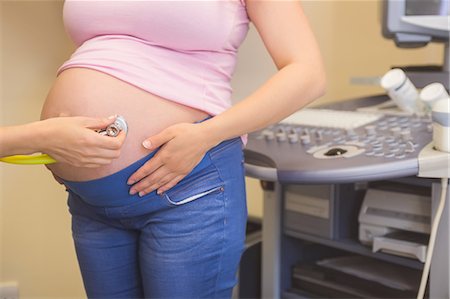 Young Doctor checking her pregnant patient at the ultrasound clinic Stock Photo - Premium Royalty-Free, Code: 6109-08434625