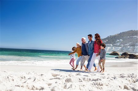 Cute family on holidays walking on the beach Stock Photo - Premium Royalty-Free, Code: 6109-08434726