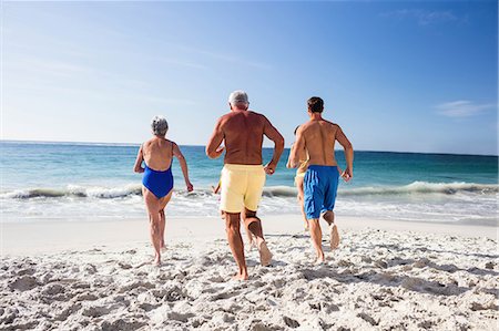 elderly women in bathing suits& - Cute family running into the sea on the beach Stock Photo - Premium Royalty-Free, Code: 6109-08434842