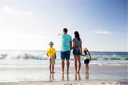 simsearch:6109-06003758,k - Cute family standing in the sand on the beach Stock Photo - Premium Royalty-Free, Code: 6109-08434868