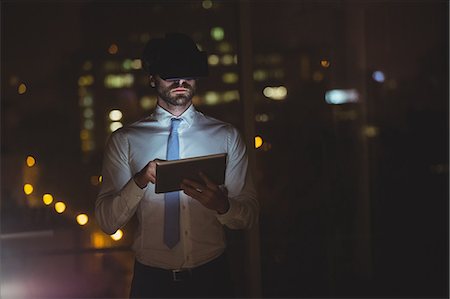 Businessman using technology at night Stock Photo - Premium Royalty-Free, Code: 6109-08581432