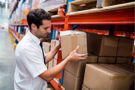 staff (male) - Warehouse manager taking package in shelf Stock Photo - Premium Royalty-Free, Code: 6109-08581525