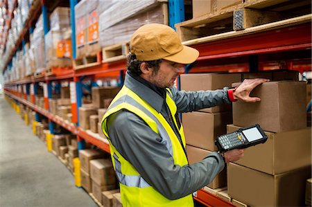 Warehouse worker using hand scanner Stock Photo - Premium Royalty-Free, Code: 6109-08581680