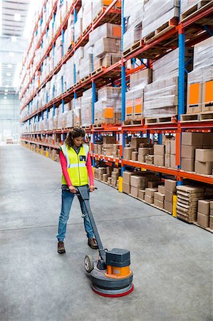 Woman cleaning warehouse floor with machine Stock Photo - Premium Royalty-Free, Code: 6109-08581689