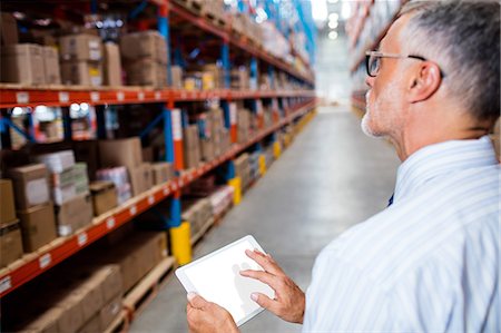 simsearch:400-04283915,k - Focus on foreground of warehouse manager taking notes Stock Photo - Premium Royalty-Free, Code: 6109-08581638