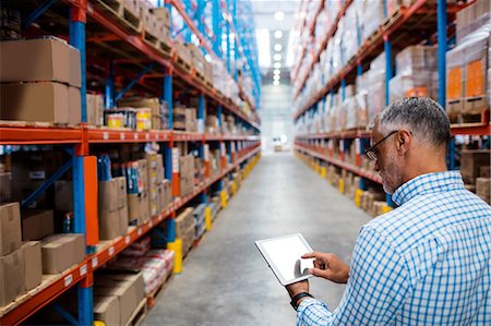 distribution warehouse - Manager using his tablet Stock Photo - Premium Royalty-Free, Code: 6109-08581715