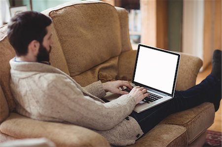 stylized house - Close up view of hipster man using laptop in his sofa Stock Photo - Premium Royalty-Free, Code: 6109-08581996