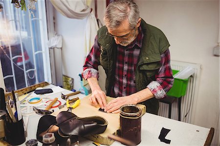 simsearch:6109-08582278,k - Cobbler pressing his hands against the material Stock Photo - Premium Royalty-Free, Code: 6109-08582192