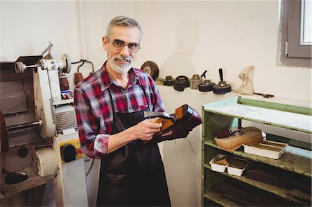 focused - Cobbler smiling and posing Stock Photo - Premium Royalty-Free, Code: 6109-08582125