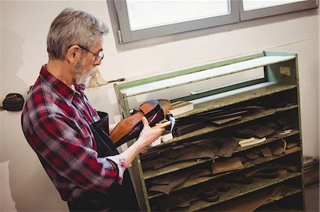 simsearch:6109-08582278,k - Profile view of cobbler making a shoe Stock Photo - Premium Royalty-Free, Code: 6109-08582130