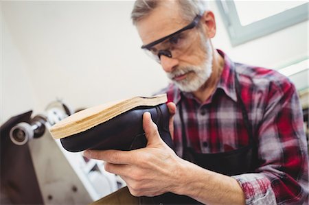 simsearch:6109-08582278,k - Close up of cobbler checking a shoe Stock Photo - Premium Royalty-Free, Code: 6109-08582246