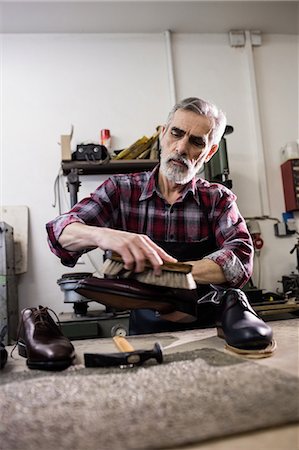 simsearch:6109-08582278,k - Low angle view of cobbler polishing a shoe Foto de stock - Sin royalties Premium, Código: 6109-08582255